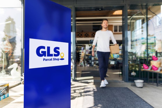 Man coming out of a GLS Parcel Shop