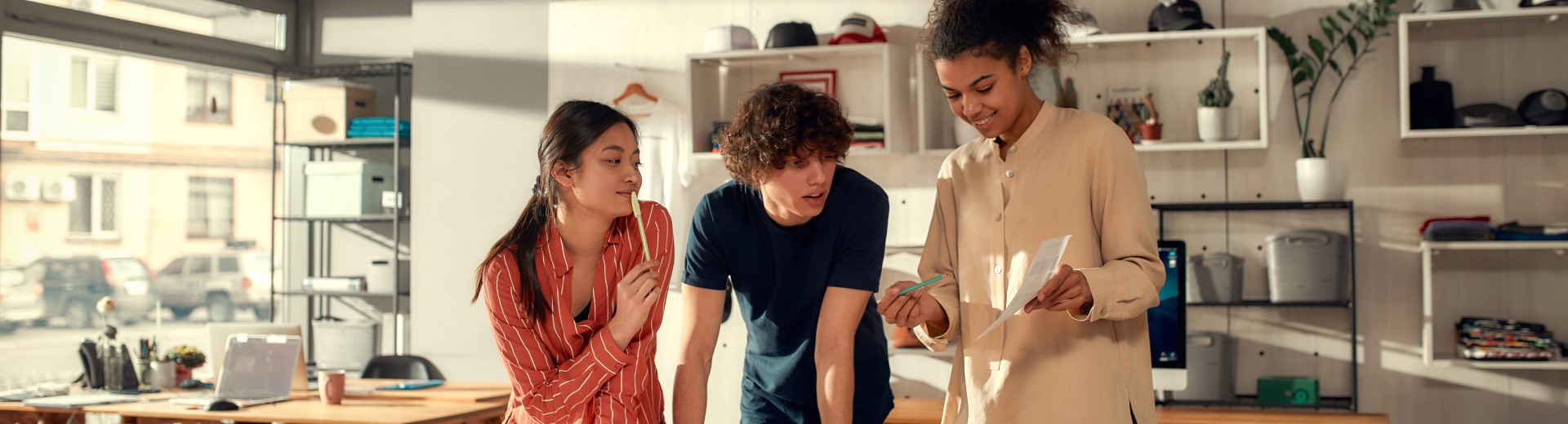 Three people looking at a sheet of paper