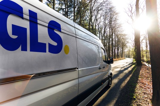 A GLS van in the sunny woods