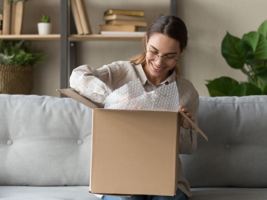 A woman unpacks a parcel