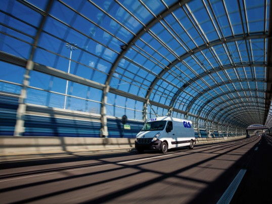 Parcel van driving on European bridge