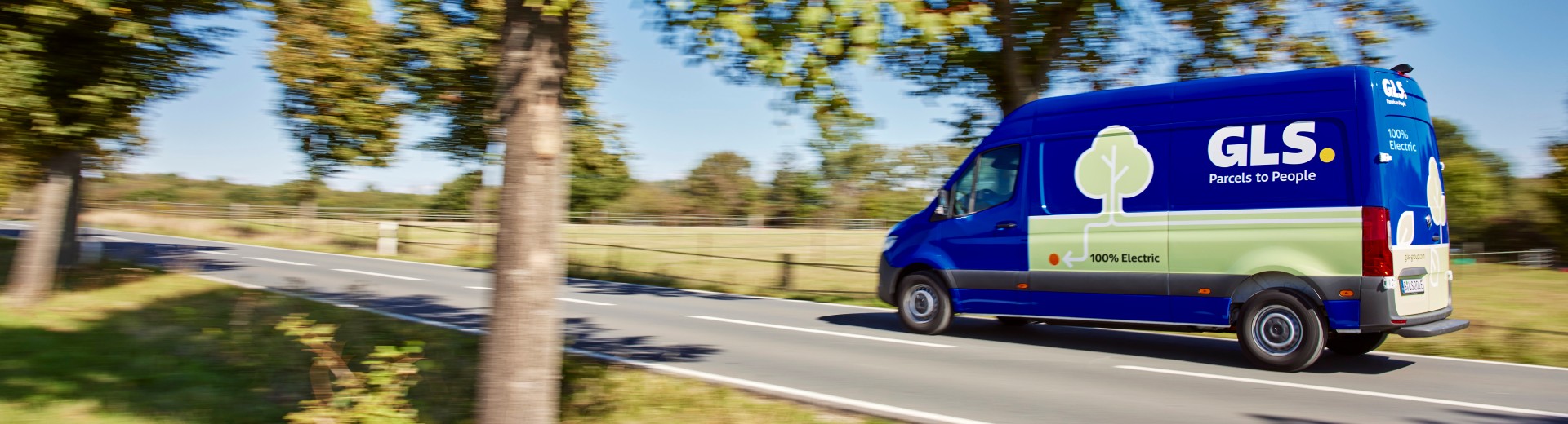 Electric delivery vehicle driving through nature