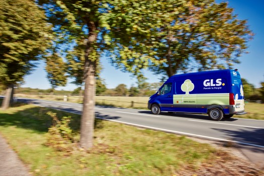 Electric delivery vehicle driving through nature