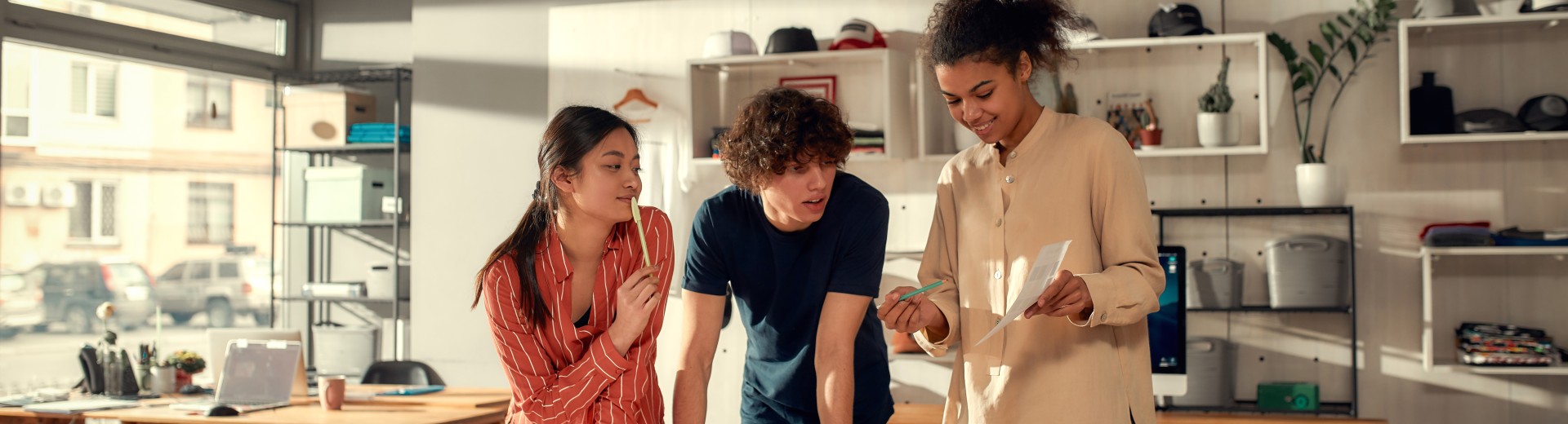 Three people looking at a piece of paper